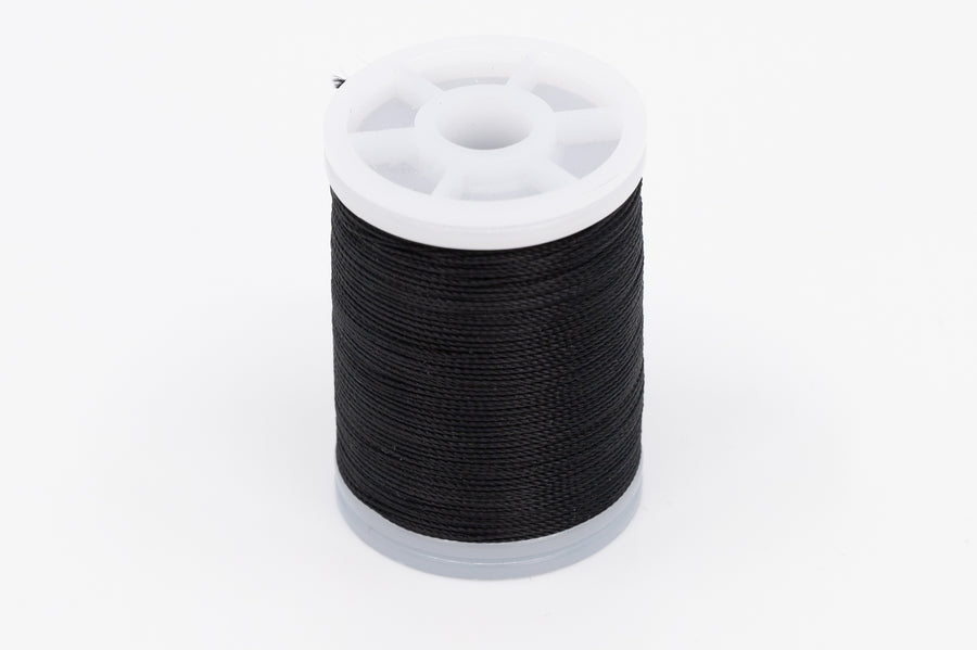 Spool of Black Nylon Thread. a Small Part of the Thread from the